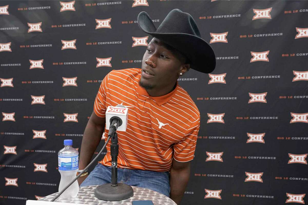 Texas linebacker DeMarvion Overshown takes a seat before speaking to reporters at the NCAA college football Big 12 media days in Arlington, Texas, Thursday, July 14, 2022. (AP Photo/LM Otero)