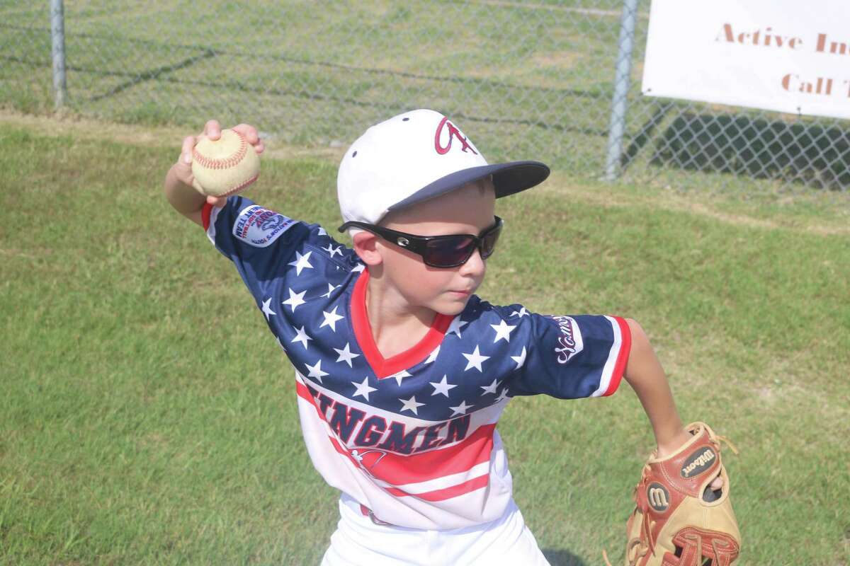 Nathan Koenig, a member of the Normoyle Swingmen 9U all-star squad, warms up with a teammate prior to a Thursday game at the Ruth Minchen Athletic Complex. The boys from the San Antonio area will oppose La Porte at 11 on Friday.