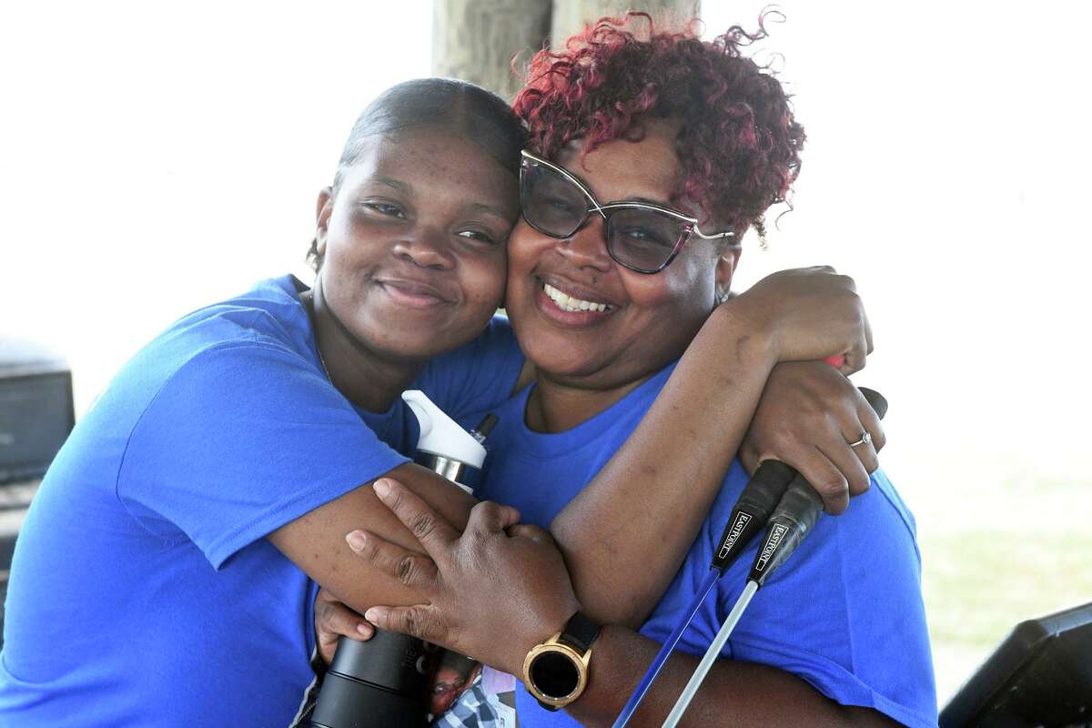 Teri Lynn Littleberry, right, Elijah Page’s mother, gets a hug from Page’s girlfriend, Rakeria Thomas, during a fundraising picnic in Stratford, Conn. July 14, 2022. Thursday marked the first anniversary of Page’s death in an automobile accident in Bridgeport.