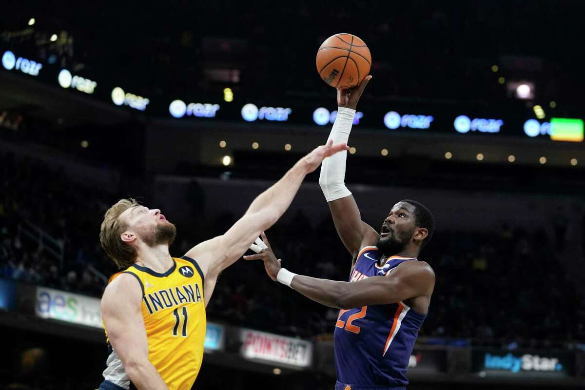 Phoenix Suns center Deandre Ayton shoots over the Indiana Pacers’ Domantas Sabonis during the second half of a game in Indianapolis on Jan. 14. Sabonis was later traded to the Kings.
