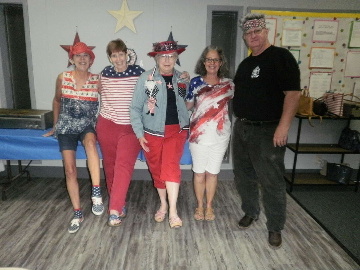 From left, Belle Harris, Linda Buzan, Ann Parish, Dianne Anderson and Bill Brooks show off the red, white and blue after the belated fourth of July party and game at the Allison Bridge Center.