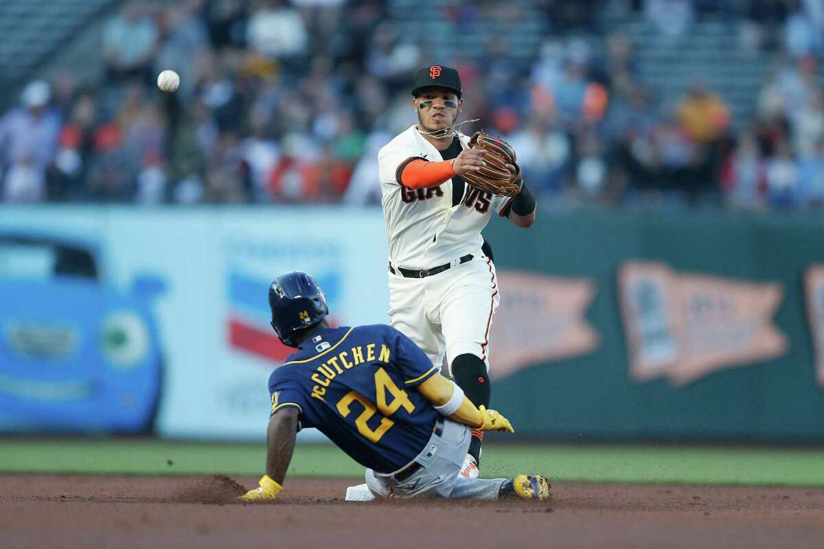 SAN FRANCISCO, CALIFORNIA - JULY 14: Thairo Estrada #39 of the San Francisco Giants gets the out at second base of Andrew McCutchen #24 of the Milwaukee Brewers in the top of the first inning at Oracle Park on July 14, 2022 in San Francisco, California. (Photo by Lachlan Cunningham/Getty Images)