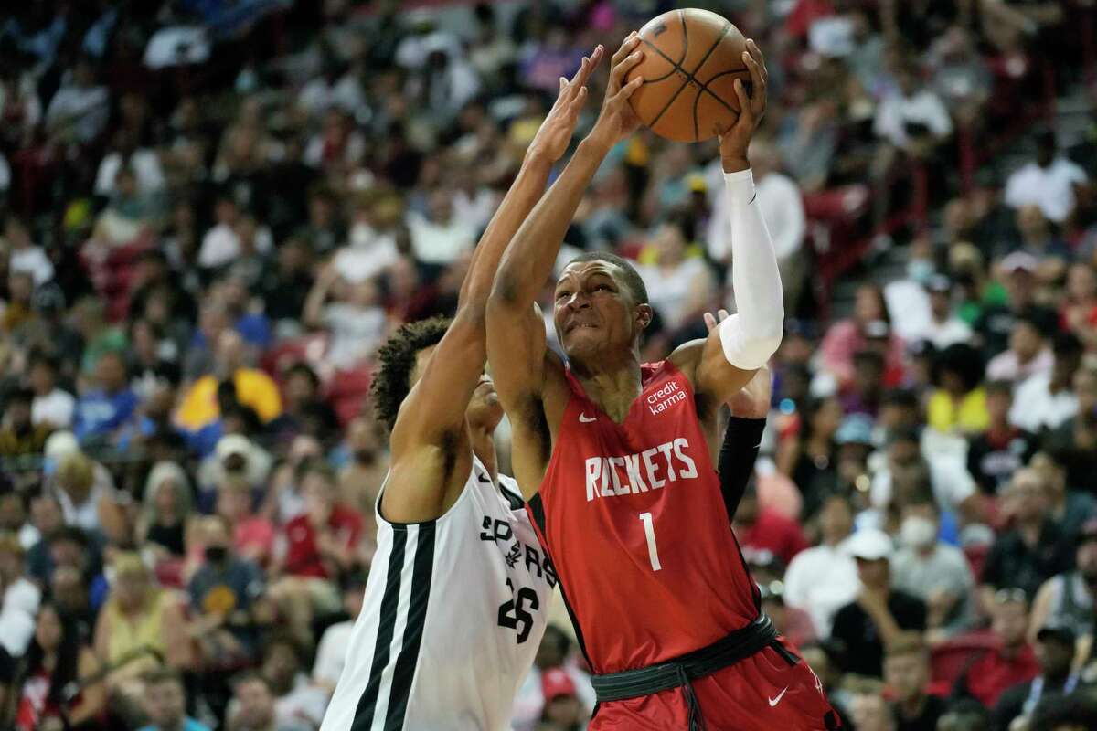 Houston Rockets' Jabari Smith Jr. drives against San Antonio Spurs' Dominick Barlow during the first half an NBA summer league basketball game Monday, July 11, 2022, in Las Vegas. (AP Photo/John Locher)