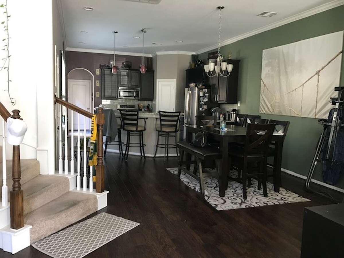 Before: Engineered wood floors were dark with reddish undertones. Those were replaced with a lighter color of luxury vinyl tile that looks like wood.