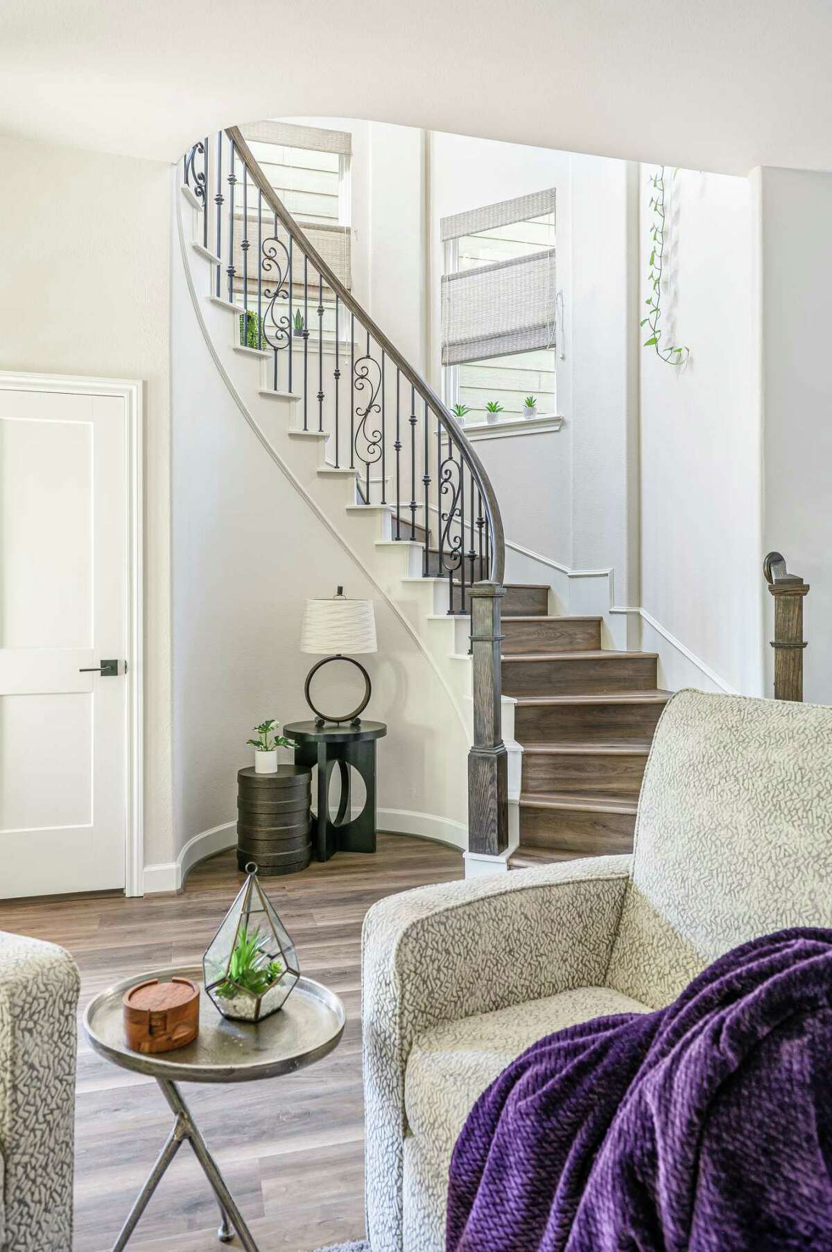 After: Luxury vinyl tile extends up the stairs and to part of the second floor. Traditional windows with seagrass shades replaced glass block openings.