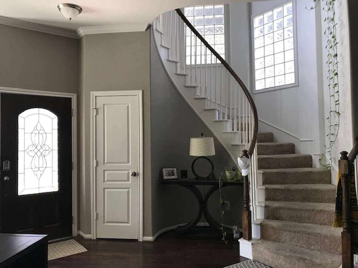 Before: The stairs had white wood balusters and glass block windows.