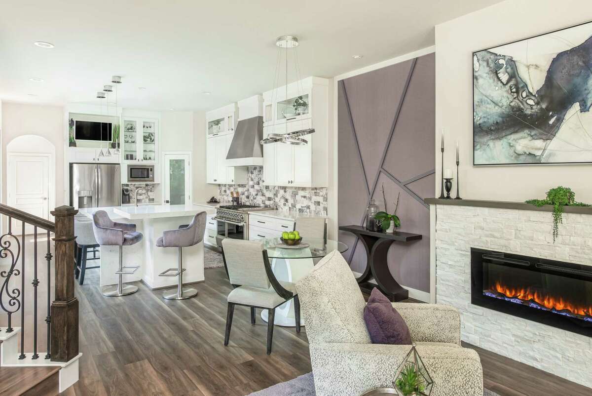 After: Purple and plum are accent colors in an otherwise neutral main living area. Stacked quartz adds some sparkle to a cozy spot with an electric fireplace.