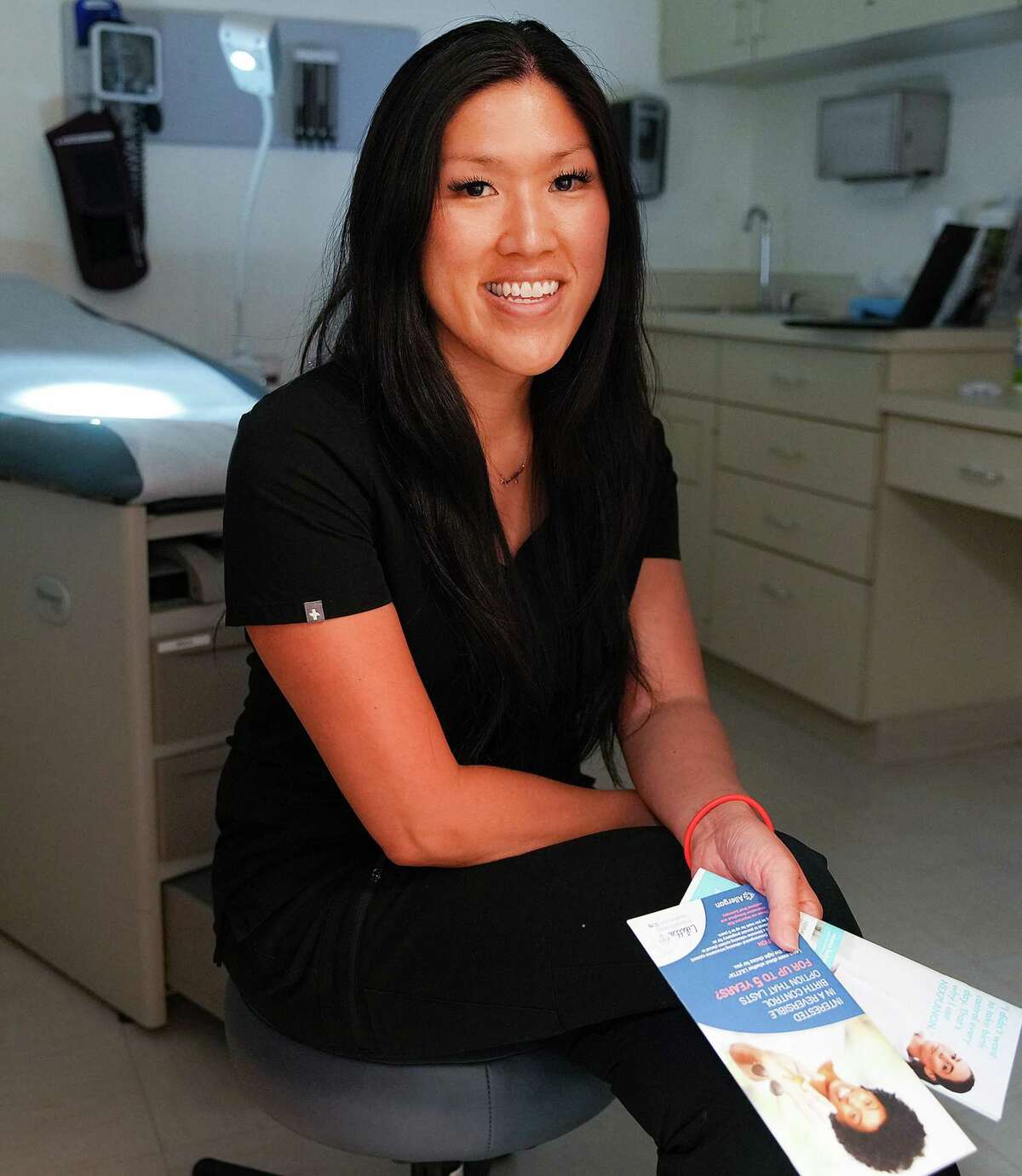 Dr. Vian Nguyen, an OB-GYN, at Legacy Community Health Clinic, holds some contraception pamphlets its clients have access too on Monday, July 11, 2022 in Houston.
