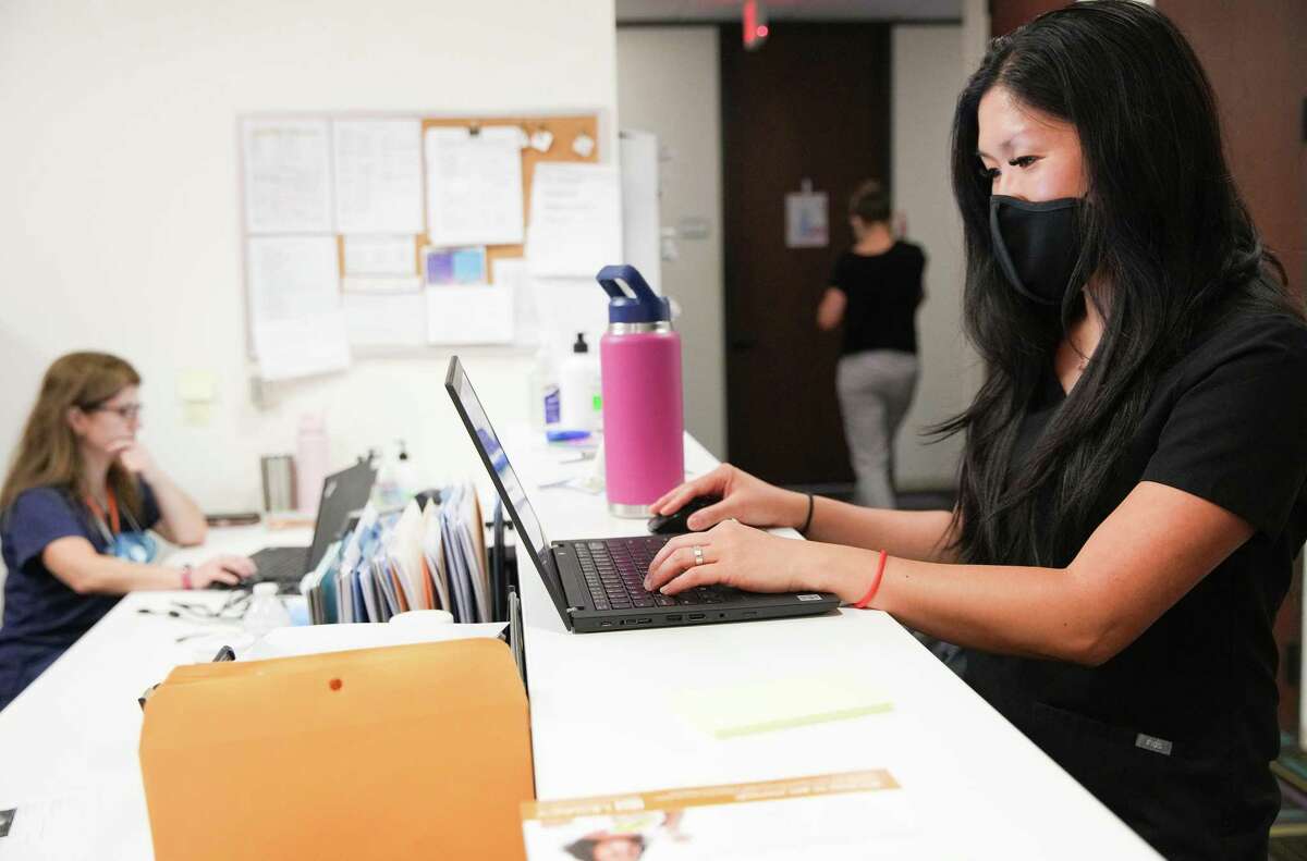 Dr. Vian Nguyen, right, an OB-GYN, at Legacy Community Health Clinic, prepares for patients on Monday, July 11, 2022 in Houston.