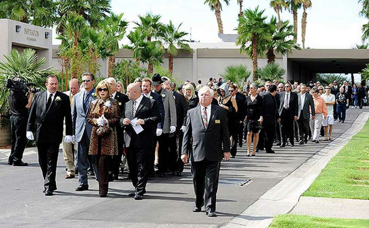 HENDERSON, NV - OCTOBER 04: Mourners walk to the burial site for Tony Curtis during the actor's funeral at Palm Mortuary & Cemetary October 4, 2010 in Henderson, Nevada. Curtis died on September 29 at age 85. (Photo by Ethan Miller/Getty Images)