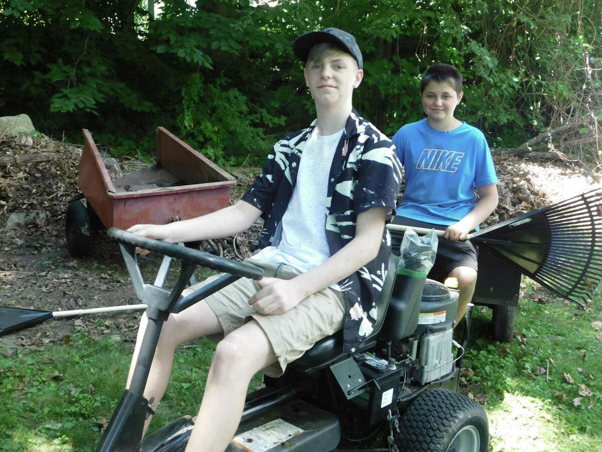 Micah West, left, Austin Loyot, right, both of Torrington, started their own lawn care service this spring.