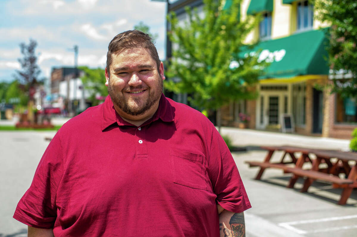 Midland resident and state representative candidate Matt Dawson poses on July 6 in Downtown Midland.