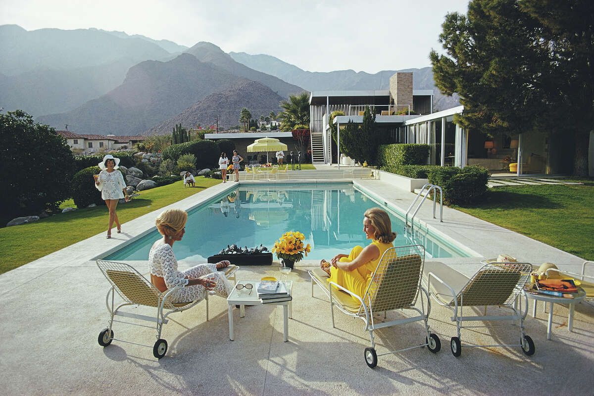 A desert house in Palm Springs designed by Richard Neutra for Edgar J. Kaufmann. Lita Baron, far left, approaches Helen Dzo Dzo, left, and Nelda Linsk, wife of art dealer Joseph Linsk.