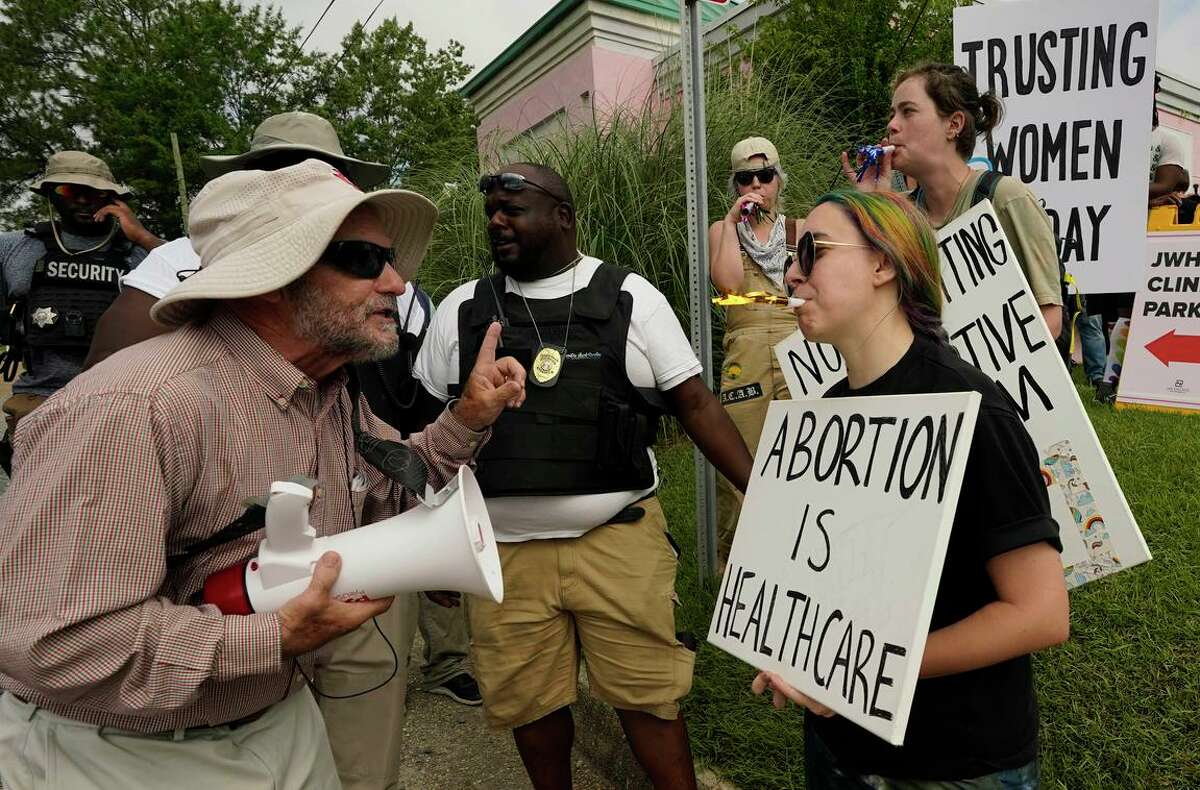 Antiabortion activist Doug Lane (left) and abortion rights supporters clash at the Jackson Women’s Health Organization clinic in Jackson, Miss., this month.