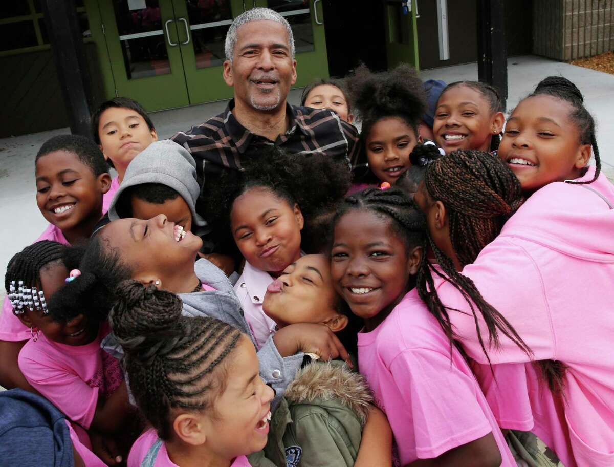 James Spingola with children outside the Ella Hill Hutch Community Center in 2018.