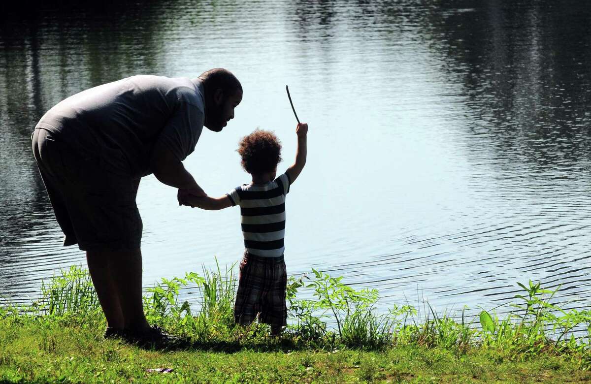 A man and his son explore at the bank of the reservoir at Frank P. Witek Memorial Park in Derby, Conn., on Tuesday August 1, 2017.