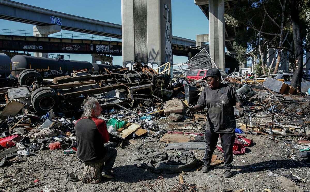Ramona Choyce recounts the moment when an April fire killed one person at a homeless encampment on Wood Street in Oakland, Calif. on Monday, May 3, 2022. The encampment is one of the largest in the city and has been plagued with problems such as illegal dumping and fires for years. Both the city and the camp’s residents have different ideas for what the future should be for the land and the people who live there.