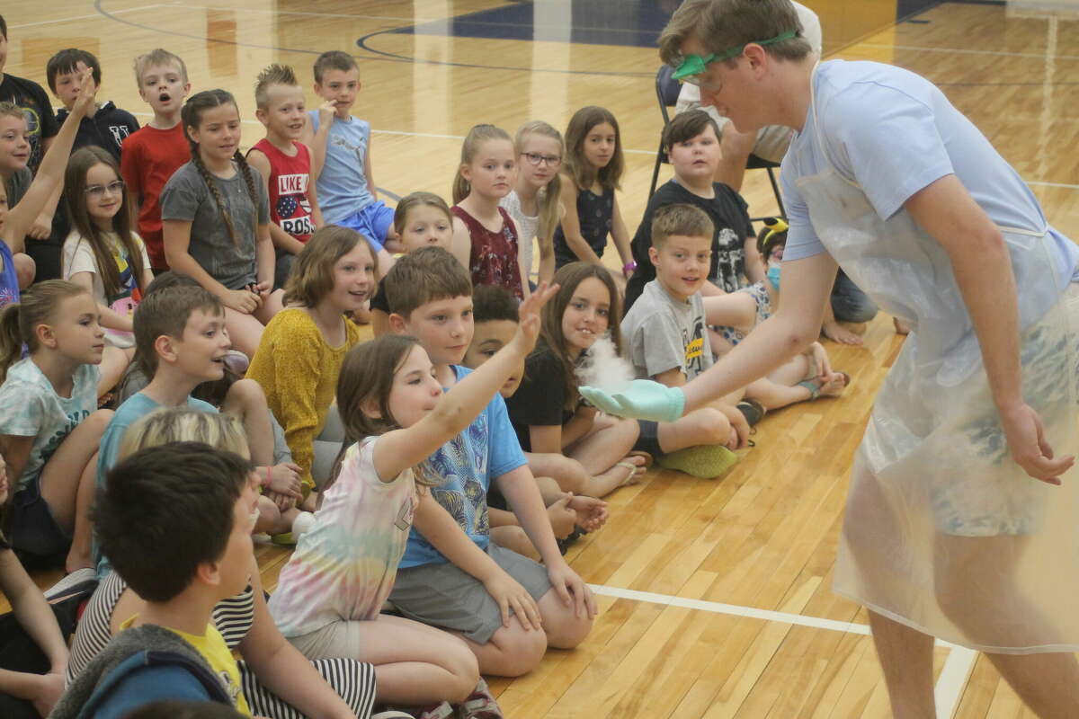 In this file photo, Jeffery Huber, Manistee High School Advanced Placement chemistry student, lets a third grader burst a bubble made with dry ice and dish soap on May 13 during a science demonstration at Kennedy Elementary School.