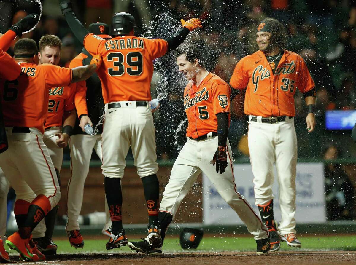 SAN FRANCISCO, CALIFORNIA - JULY 15: Mike Yastrzemski #5 of the San Francisco Giants celebrates with teammates after hitting a walk-off grand slam in the bottom of the ninth inning against the Milwaukee Brewers at Oracle Park on July 15, 2022 in San Francisco, California. (Photo by Lachlan Cunningham/Getty Images)