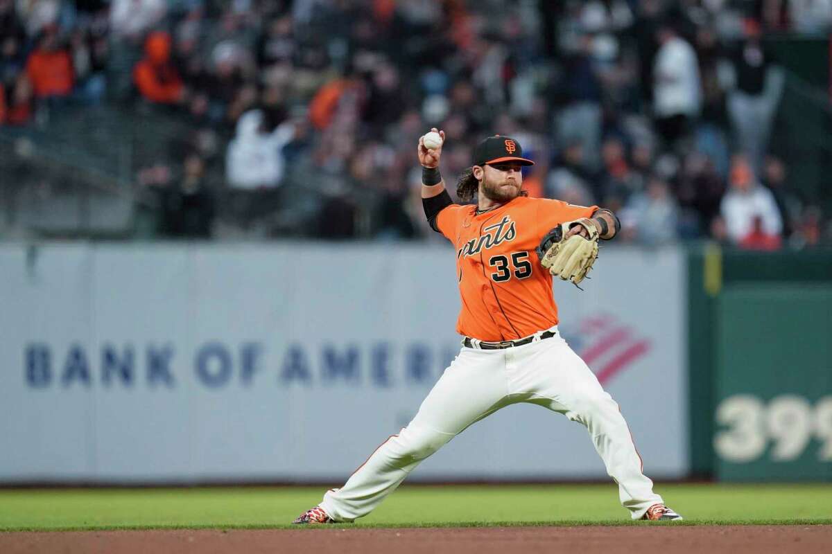 San Francisco Giants shortstop Brandon Crawford throws to first base for the out on Milwaukee Brewers' Mike Brosseau during the fourth inning of a baseball game in San Francisco, Friday, July 15, 2022. (AP Photo/Godofredo A. Vásquez)