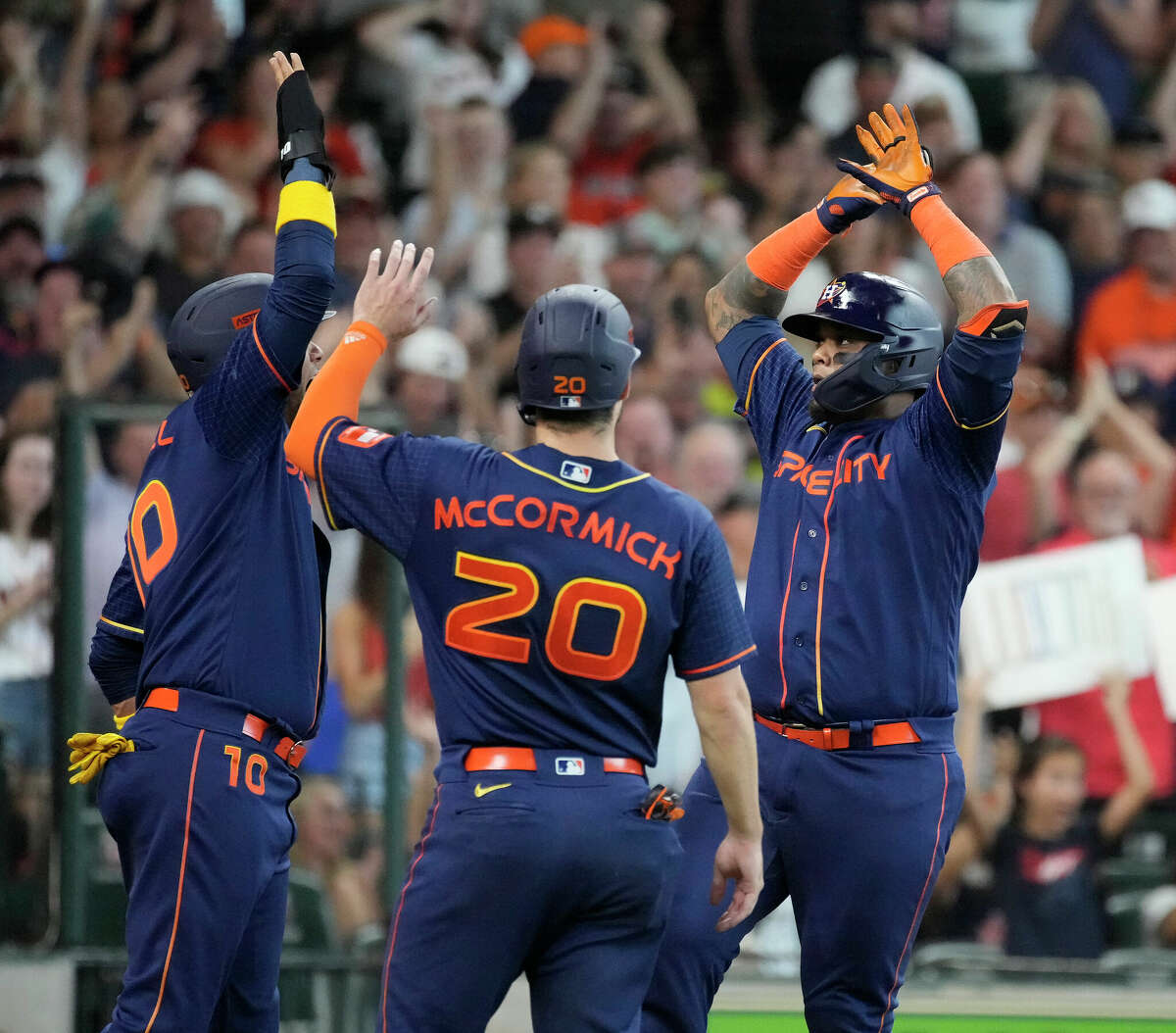 Houston Astros' Martin Maldonado (15) celebrates with Chas McCormick (20) and Yuli Gurriel (10) after hitting a grand slam off of Oakland Athletics starting pitcher Jared Koenig (46) during the second inning of a MLB baseball game at Minute Maid Park on Saturday, July 16, 2022 in Houston.