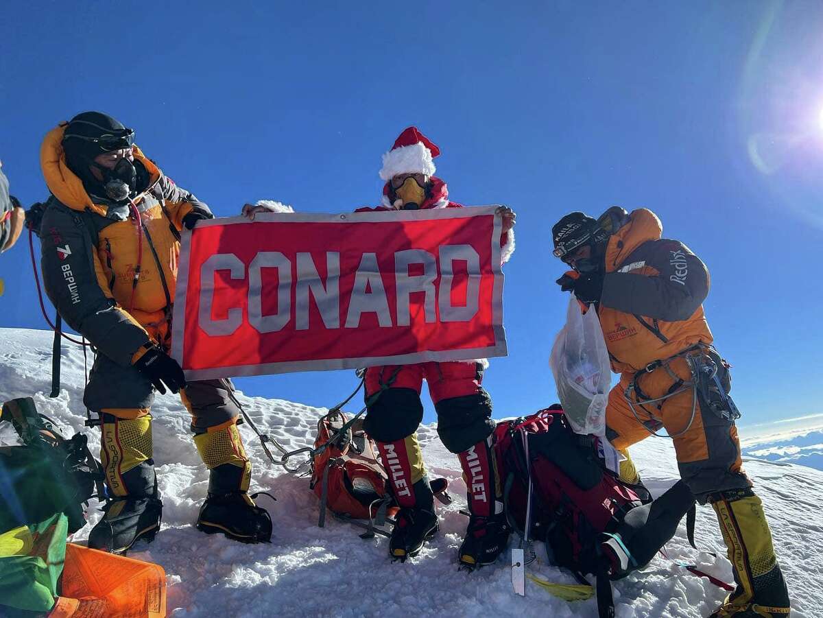 Lhakpa Sherpa flies a Conard High School flag on Everest.