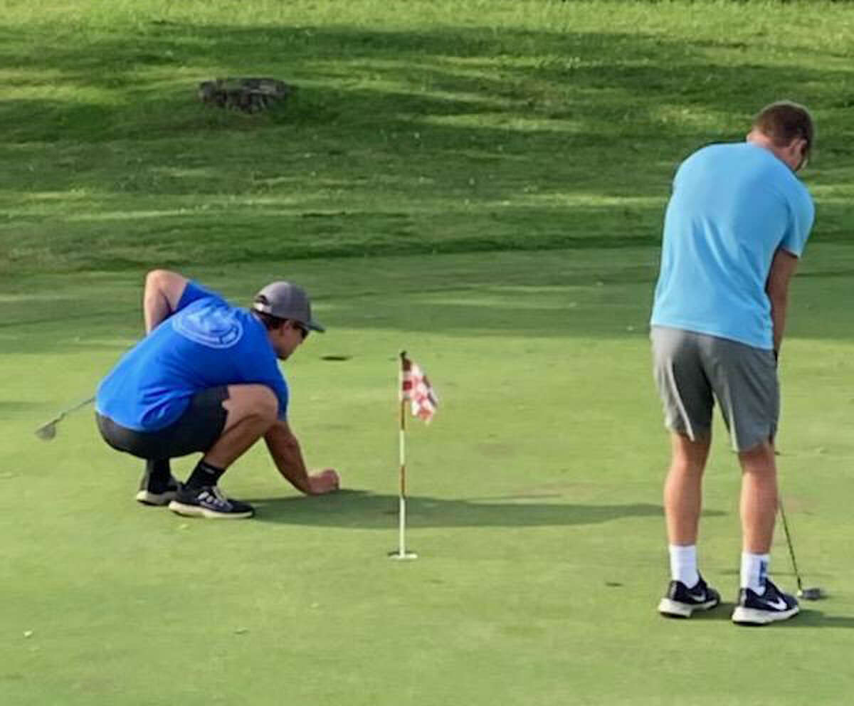 Evart golfers work on their putting during a recent youth league outing.