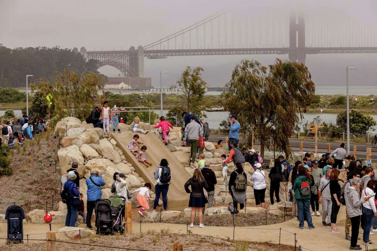 Families flock to the playground at the Presidio’s new Tunnel Tops park in San Francisco on Sunday. After years of planning and delays, the park is now open to the public.