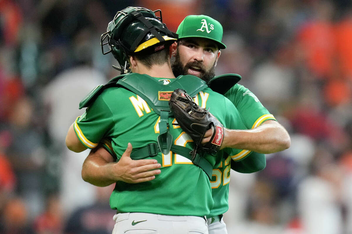 Oakland Athletics relief pitcher Lou Trivino, right, celebrates the team's win over the Houston Astros with catcher Sean Murphy in a baseball game, Sunday, July 17, 2022, in Houston. (AP Photo/Eric Christian Smith)