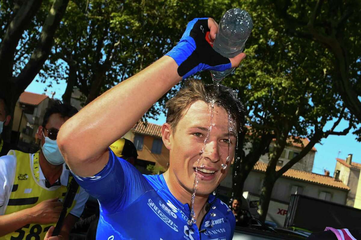 Stage winner Belgium's Jasper Philipsen poured water over his head after the fifteenth stage of the Tour de France cycling race over 202.5 kilometers (125.5 miles) with start in Rodez and finish in Carcassonne, France, Sunday, July 17, 2022. (Tim De Waele/Pool Photo via AP)