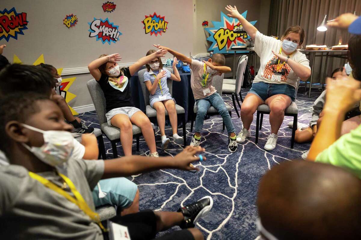 Campers play games to break the ice during the first day of in-person camp at the Four Seasons Hotel in downtown Houston on Sunday, July 17, 2022.