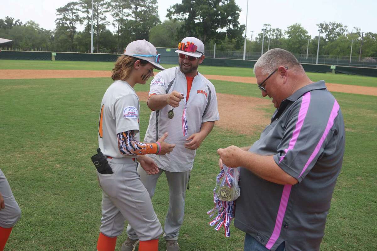 Tournament chairman Billy Brooks and NASA Orange 14s manager Daniel Wheeler were in charge of handing out the medals to the players following Sunday afternoon's Coast Region title contest.