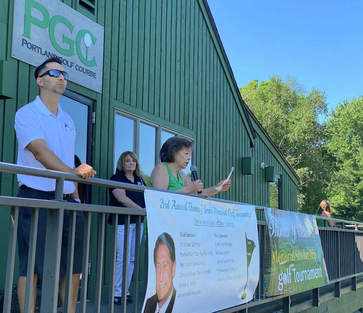 Maryann Serra speaks before a field of 144 tees off in the third annual Thomas J. Serra Memorial Golf Tournament. Also pictured: Serra's son, Jason, and Portland Golf Course owner/operator Laurie Kelley.