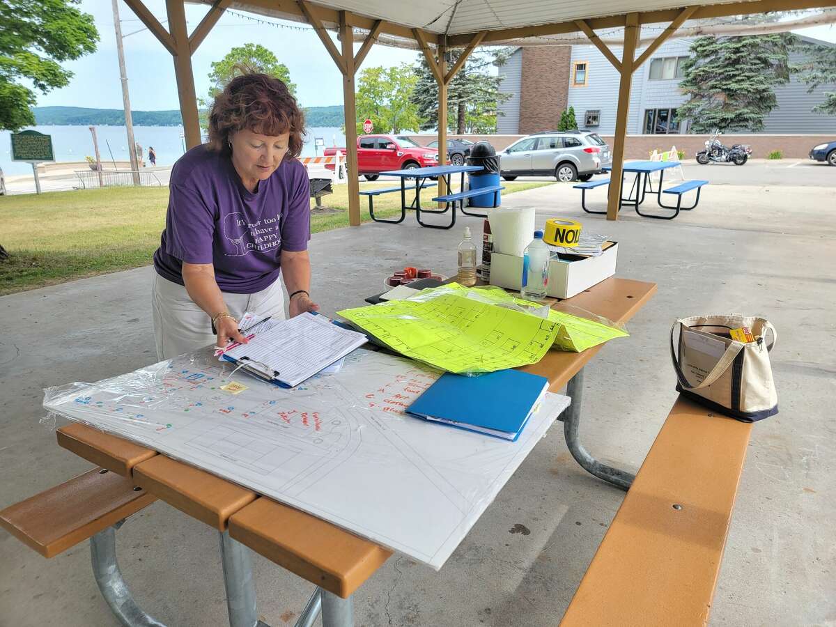 Vicki Carpenter, event planner and member of the Crystal Lake and Watershed Association, looks over plans for the Beulah Art Fair a day before the event. 