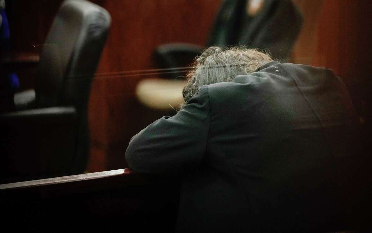Wallis Nader lays her head on a courtroom bench before a hearing about her bond conditions in the 174th District Court on Monday, July 18, 2022, at the Harris County Criminal Courthouse at 1201 Franklin St. in Houston. She and two other Harris County aides are charged with steering a controversial COVID-19 vaccine contract to firm operated by a politically-connected vendor.