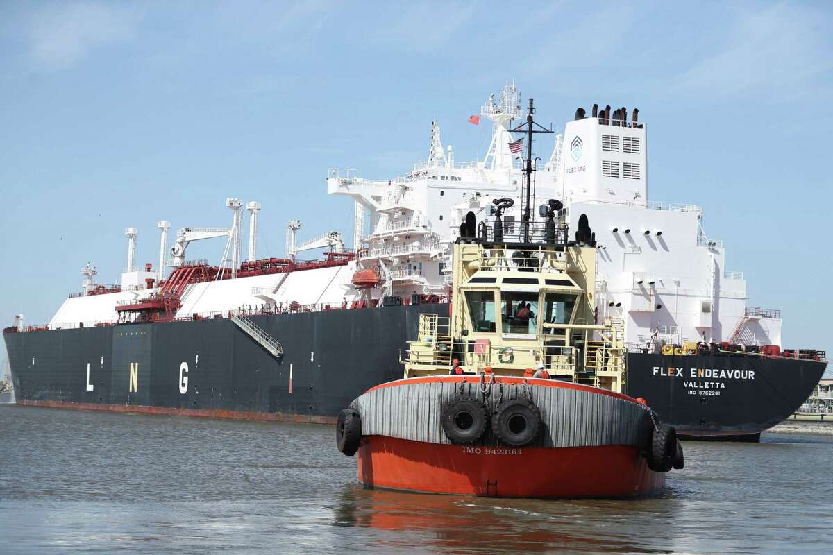 A tugboat moves past a LNG tanker during a media tour of Cheniere’s Sabine Pass LNG Terminal on Thursday, April 14, 2022 in Cameron Parish, LA.
