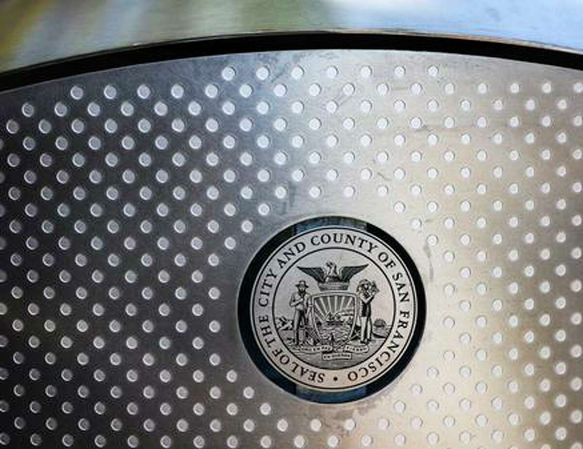 The seal of San Francisco is displayed on a soft square trash bin model at Broadway and Columbus Street.