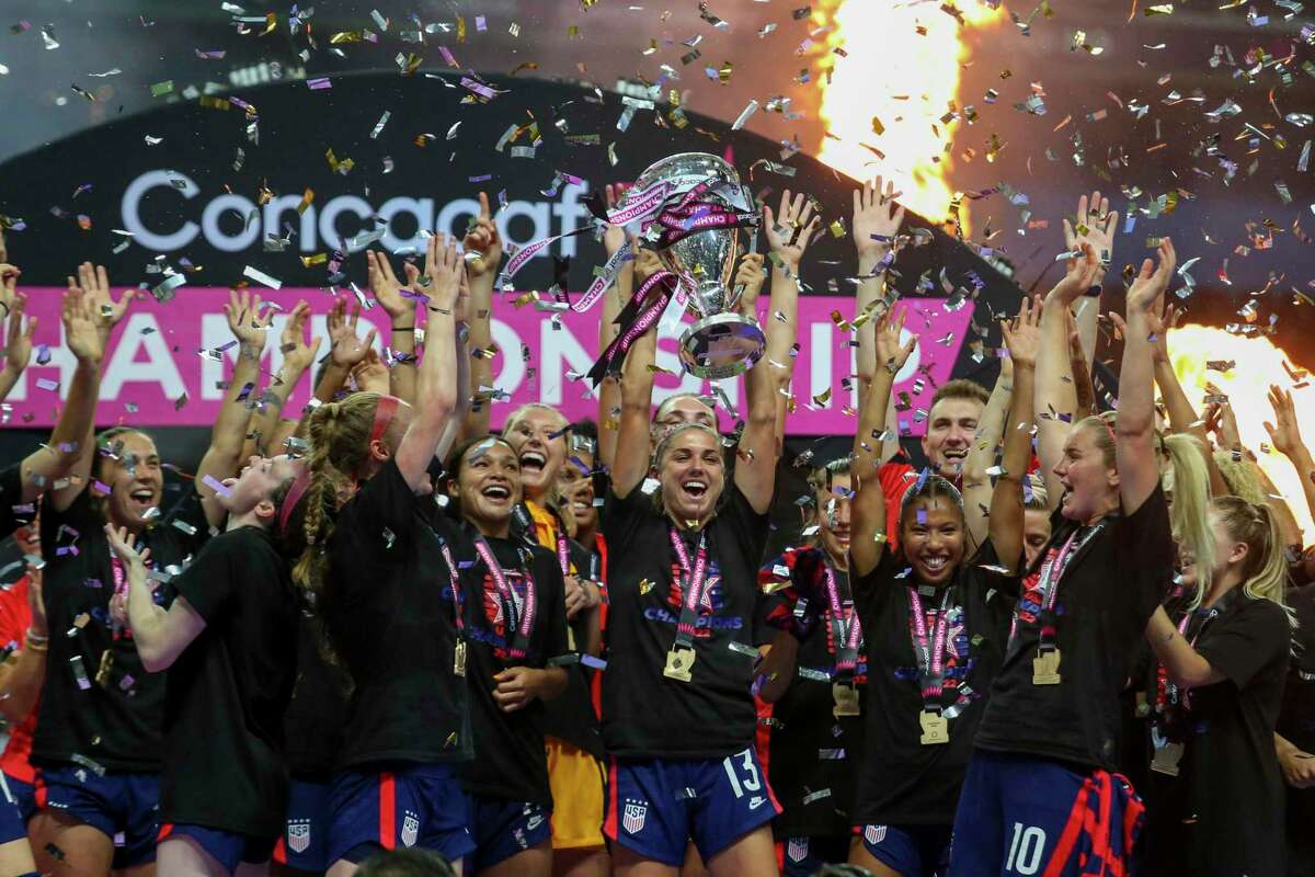 United States' Alex Morgan lifts up a trophy after winning the CONCACAF Women's Championship final soccer match against Canada in Monterrey, Mexico, Monday, July 18, 2022. (AP Photo/Roberto Martinez)
