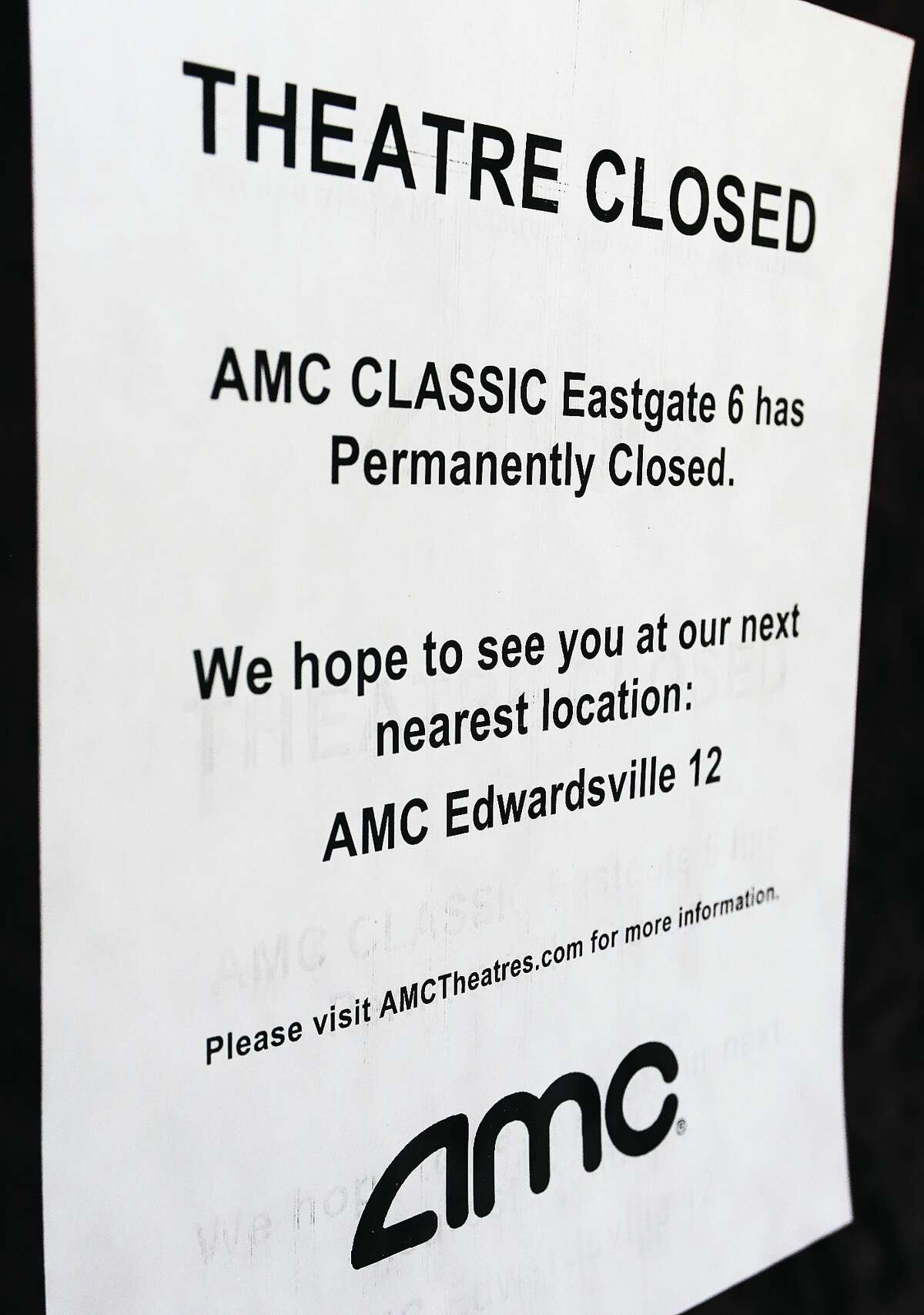 A sign taped in the window of every door at the AMC Classic Eastgate 6 movie theater in East Alton tells of its closure.