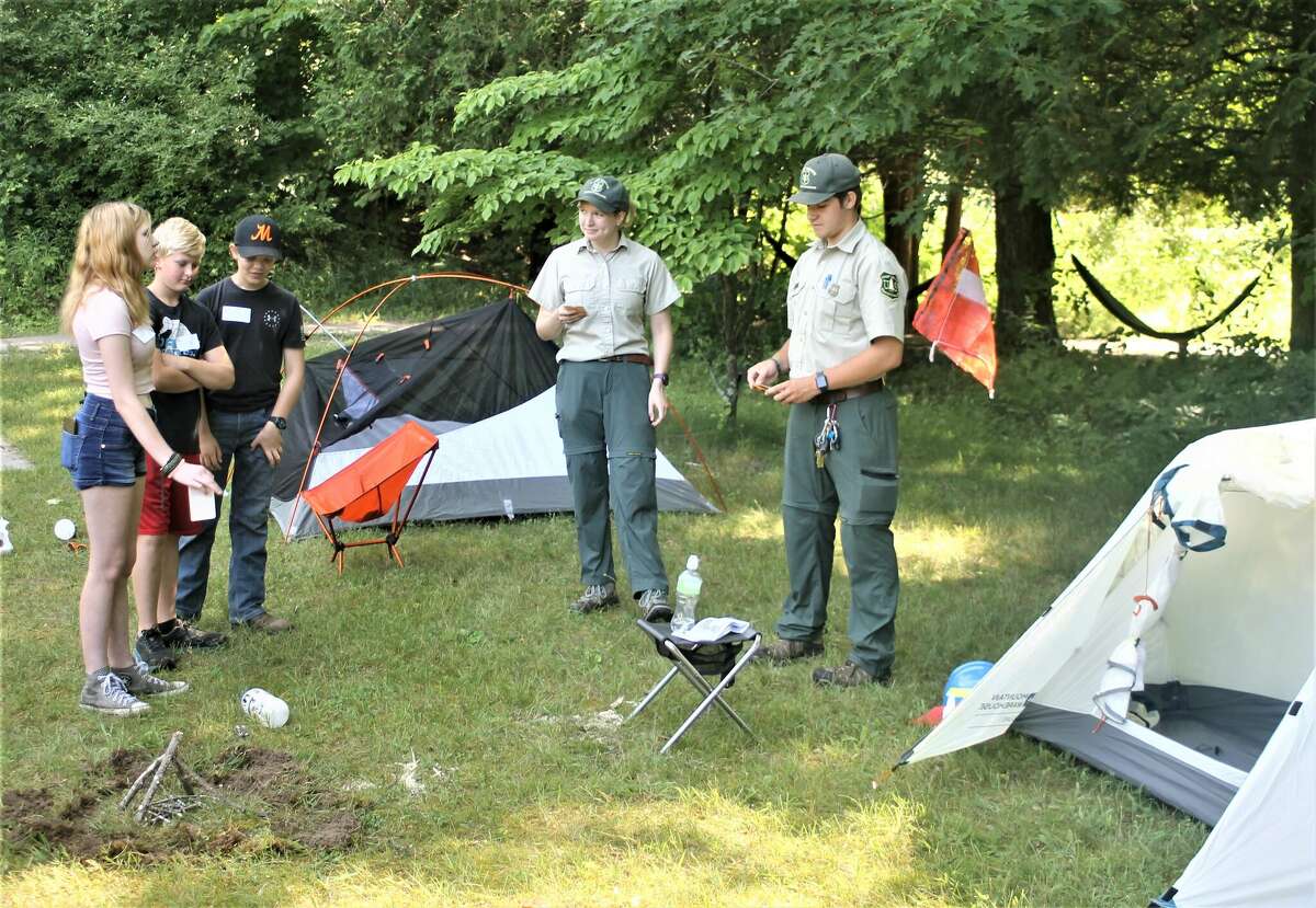 Sydney Giddings and Cole Mortensen, of the U.S. Forest Service, give a presentation Monday on the difference between a good campsite and a bad campsite.