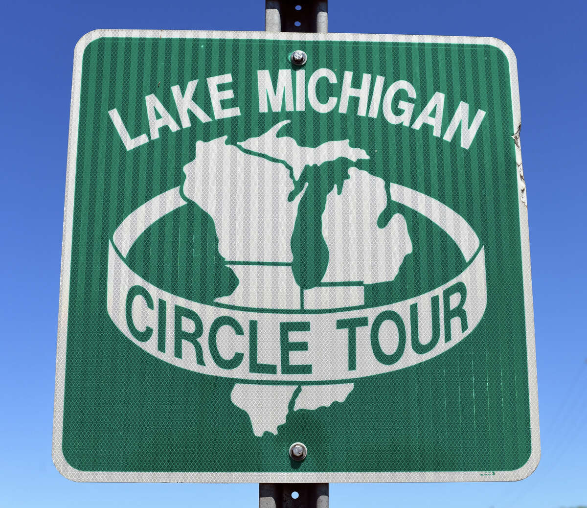 This Lake Michigan Circle Tour road sign is often visible along the 1,100 mile drive through Illinois, Indiana, Michigan and Wisconsin states. Finalized in November 1988, it became one of the most scenic routes in the United States, one of the designated scenic road systems around the Great Lakes. The other four Great Lakes - Superior, Huron, Erie, and Ontario - each have their own Circle Tour.