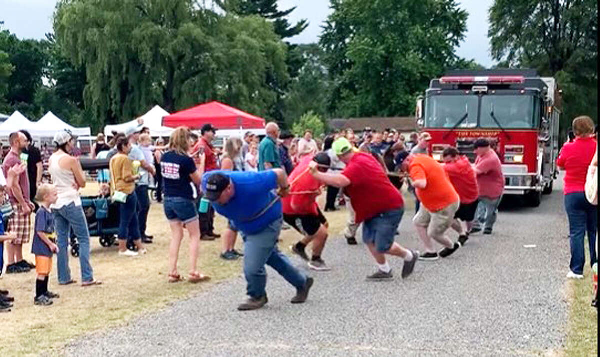 Four teams competed to see who could pull a fire truck 50 feet the fastest.