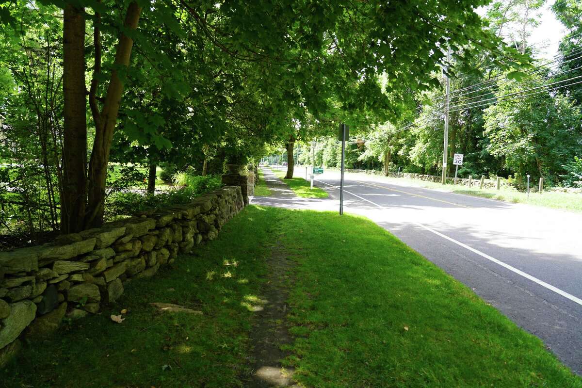 The sidewalk will be extended where the grass is worn from pedestrians, on Oenoke Ridge in New Canaan. Picture was taken July 15, 2022.