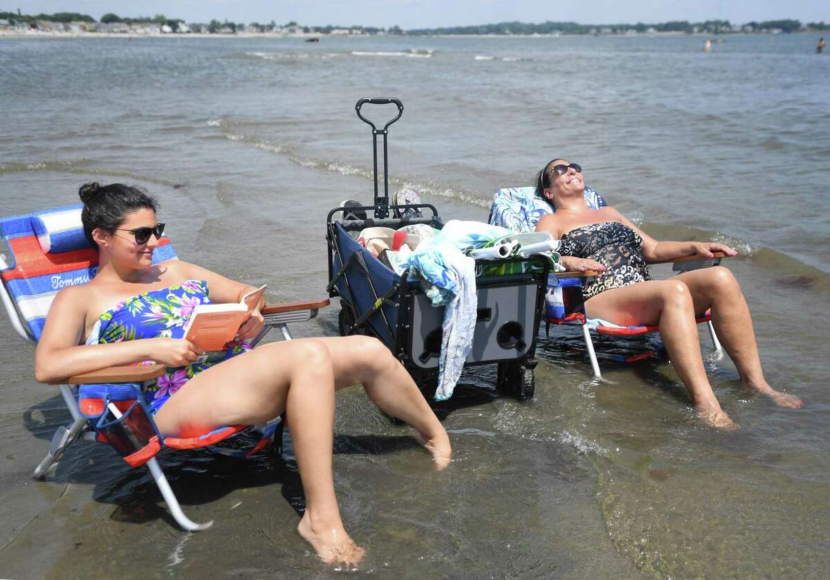 Amanda Conigliaro, left, and her mother, Valerie Conigliaro, of Shelton, keep cool at the Sound's edge at Silver Sands State Park in Milford on Tuesday.