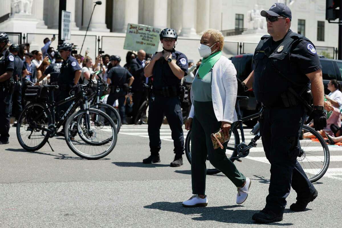 WASHINGTON, DC - JULY 19: Rep. Barbara Lee (D-CA) is detained by U.S. Capitol Police Officers after participating in a sit in with activists from Center for Popular Democracy Action (CPDA) in front of the U.S. Supreme Court Building on July 19, 2022 in Washington, DC. The CPDA held the protest with House Democrats in support of abortion rights. (Photo by Anna Moneymaker/Getty Images)