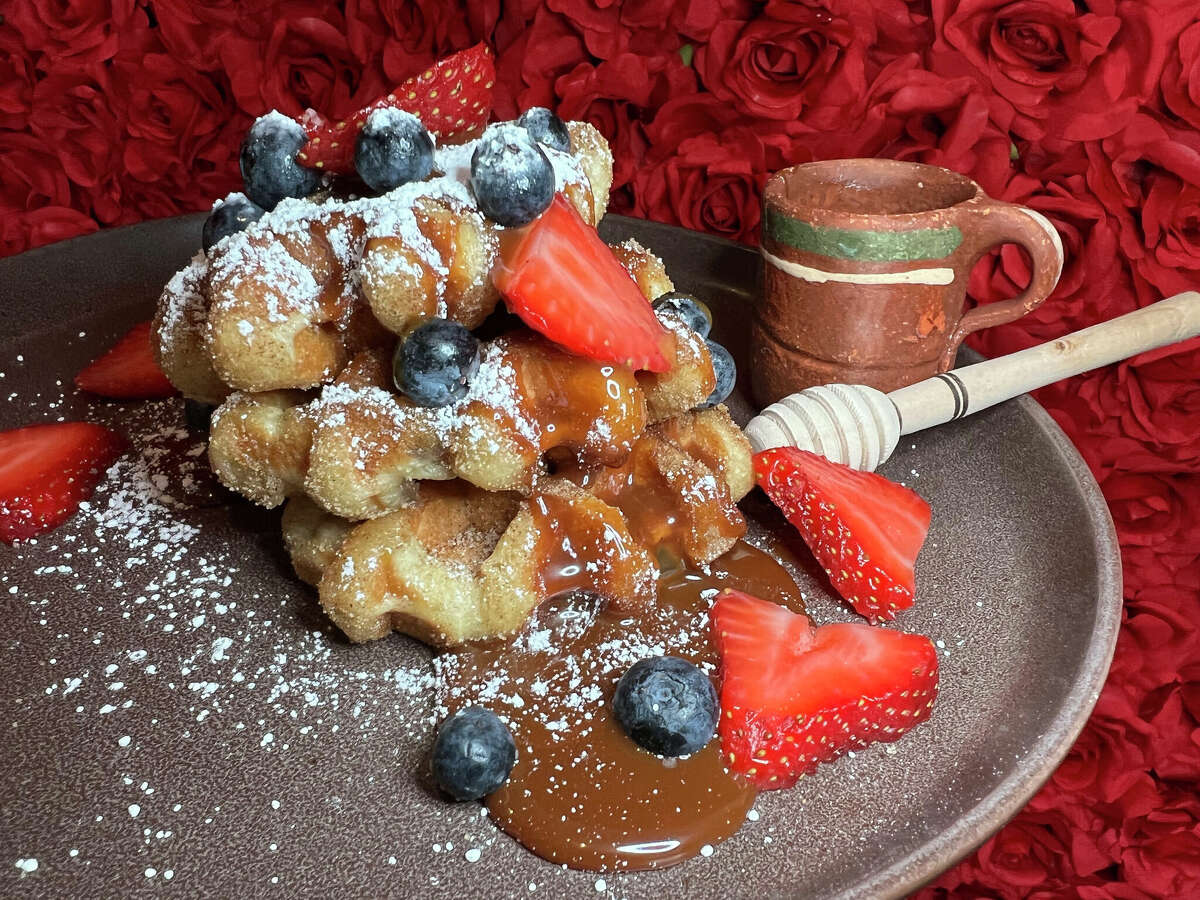 Churro waffles come with berries and a choice of toppings such as cajeta at Panfila Cantina, a Mexican restaurant and bar on Bulverde Road near TPC Parkway in San Antonio. 
