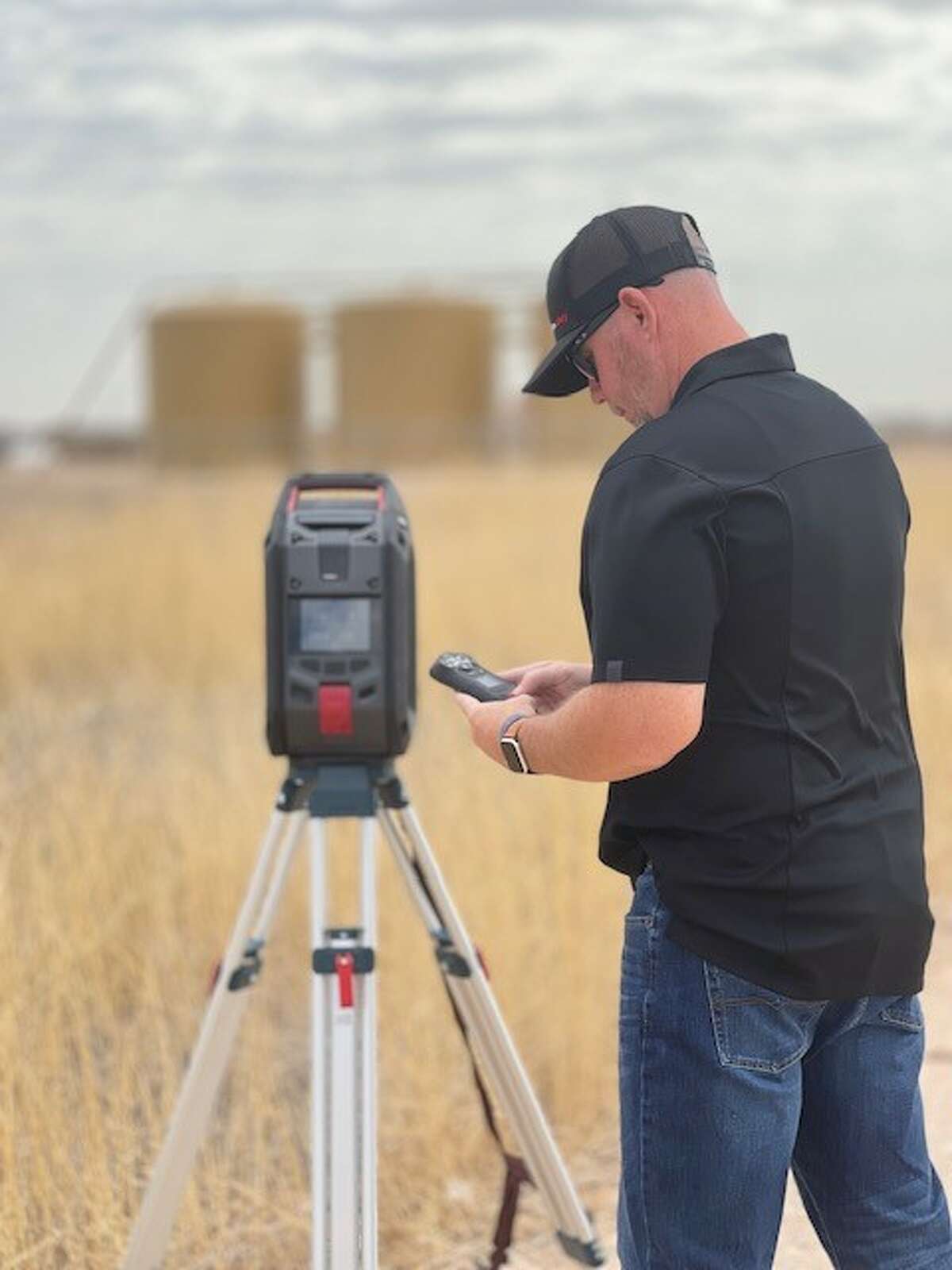 Jesse Wycoff, regional sales manager, West Texas and New Mexico for Blackline Safety, sets up an external EXO area monitor and G7C personal monitor to read gas remotely in West Texas for a customer evaluation.
