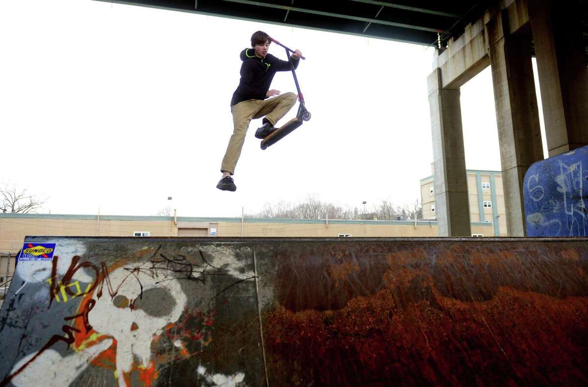 Christian Giles, of Derby, goes airborne while performing tricks with his scooter at the Shelton Skatepark in Shelton, Conn., on Saturday Jan. 14, 2017.