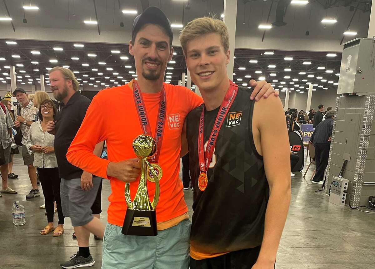 The Northeast Volleyball Club 17-1 team coach Kevin Marino and Darien's Trevor Herget with the championship trophy and medals after the win July 7. Herget was named the tournament MVP.