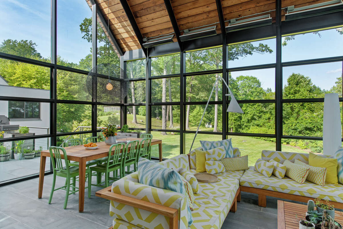 The glass-enclosed great room at the home on 10 Dragonwood Lane in Weston, Conn.